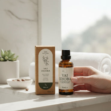 Septex cold pressed jojoba oil in a brown glass bottle with matching cardboard packaging on a bright bathroom counter.